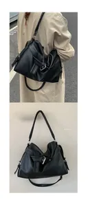 Detail of vintage black litchi leather tote bag with silver metal buckles and dual straps