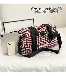 Size comparison of large red houndstooth travel bag with mobile phone and tablet