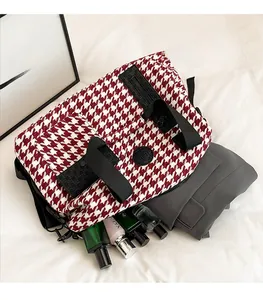 Top view of red houndstooth travel bag showing spacious interior with personal items