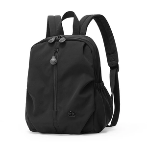 Detail view of water-resistant black nylon backpack with a vertical zipper and logo detail