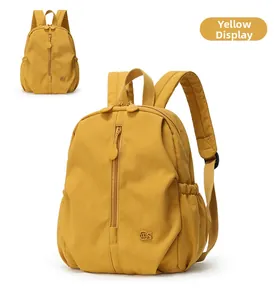 Detailed front and top view of a yellow waterproof nylon backpack with embroidery logo