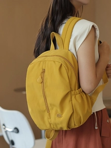 Fashionable bright yellow mini nylon backpack for women with a sleek waterproof design
