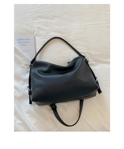 Detailed view of black litchi grain leather tote bag with silver rotating hardware buckle