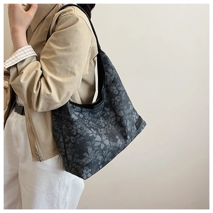 Detailed macro view of large grey wool tote bag featuring vintage black floral patterns