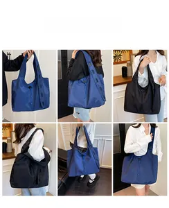Detailed views of the large capacity nylon tote bag in black and navy on models