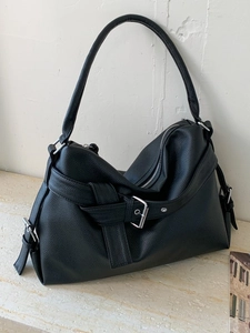 Large black pebbled leather tote bag with silver buckle strap and minimalist design