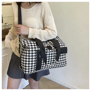 Detail of houndspurth travel bag featuring sturdy webbed handles and side zip pocket