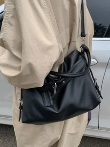 Minimalist black pebbled leather tote bag for women showing a stylish slouchy shoulder style