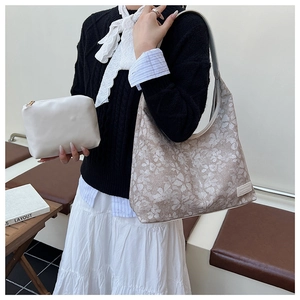 Detail of floral tote bag set with matching white leather clutch and contrast straps