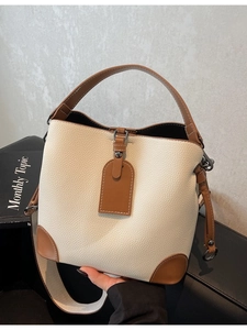Retro contrast color bucket bag in off-white and brown pebbled leather with top handle