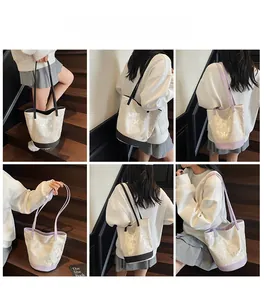 Detailed views of a large canvas tote bag with butterfly prints and rivet accents