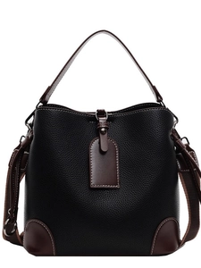 Retro bucket bag in black lychee grain leather with brown handles and a wide shoulder strap