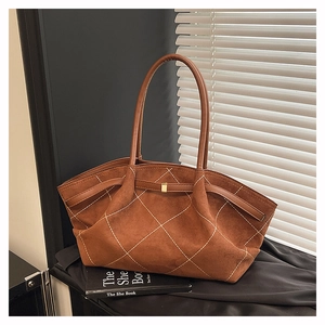 Close-up of vintage brown suede tote bag with white diamond stitching and metal buckle