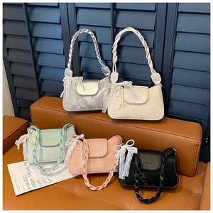 Detail of five assorted leather shoulder bags with braided handles and pearl lace bows