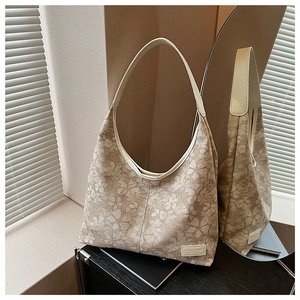 Detailed mirror view of beige floral jacquard hobo bag with structured texture