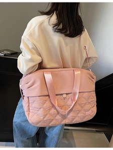 Pink quilted large capacity travel duffel bag with crossbody strap and top handles