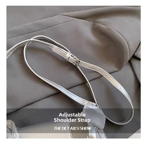 Detailed close-up of a silver adjustable shoulder strap with refined stitching and buckle