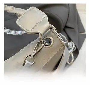 Close-up of the premium silver hook and pearl chain on this stylish grey leather bag