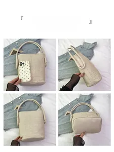 Detail view of beige woven bucket bag with leather base and handles from multiple angles