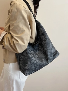 Large floral canvas shoulder bag with black leather straps and retro leaf pattern print