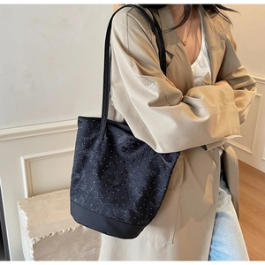 Detail shot of black polka dot canvas tote bag with reinforced base and sturdy straps