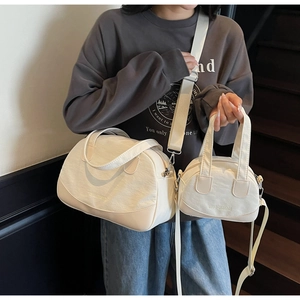 Detailed comparison of cream Boston bags in large and small sizes with silver hardware