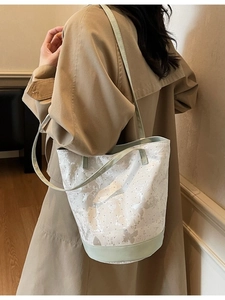 Chic canvas bucket bag with floral butterfly patterns and green leather straps for women