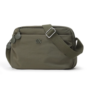 Detail view of army green nylon shoulder bag featuring multiple zip pockets and metal logo