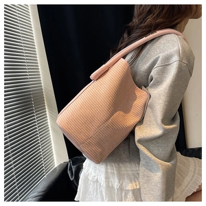 Detailed macro view showing the pink woven texture and craftsmanship of the bucket bag