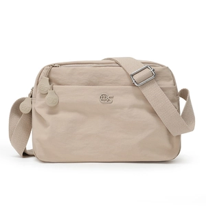 Close-up of adjustable fabric shoulder strap and silver metal buckle on nylon bag