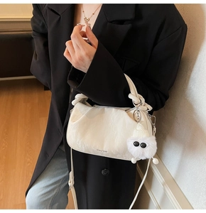White textured cloud bag featuring knot handle and cute white plush monster charm