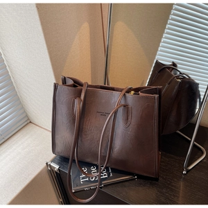 Close-up of vintage dark brown faux leather tote bag with Fashion Trend logo print
