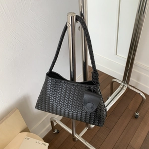 Dettaglio della borsa hobo in pelle intrecciata nera con mini pochette su appendino