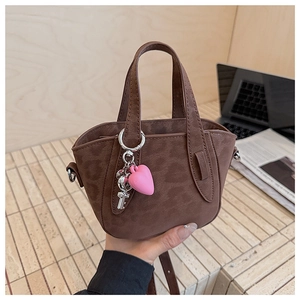 Brown crossbody handbag with leopard print nubuck finish and pink heart charm detail
