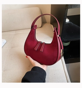 Detailed macro view of the retro burgundy frosted suede texture and smooth leather piping