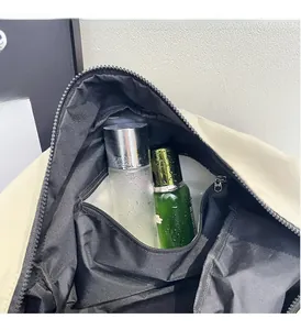 Detail of travel bag interior showing a clear waterproof dry-wet separation compartment