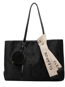 Matte black quilted tote bag with suede texture and decorative ribbon accessory