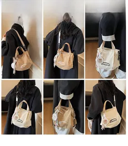 Detailed views of a casual canvas bucket bag with brand lettering and woven charm