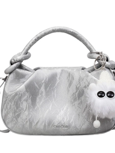 Silver metallic cloud bag with textured pleated finish and fluffy eye charm accessory