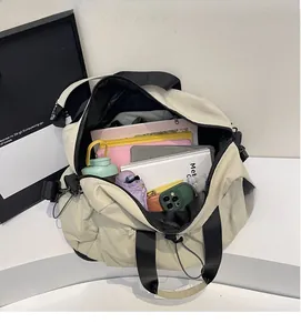 Macro view of oatmeal beige travel bag interior showing large storage capacity for tablets and books