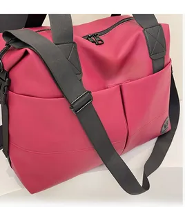Detail of rose red large backpack with adjustable black shoulder straps and smooth nylon texture