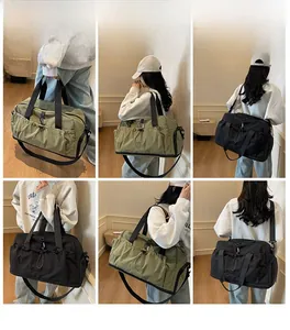 Detail view of large olive and black travel bags with dual handles and shoulder straps