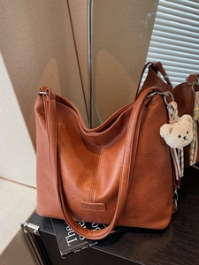 Vintage brown large capacity tote bag with plush bear charm and striped strap detail