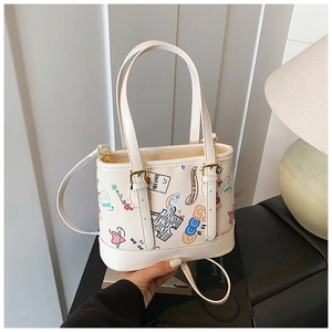 Détail du motif graffiti sur le sac cabas en toile blanche avec base en cuir renforcé