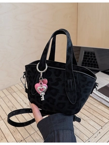 Black leopard print mini tote bag with pink heart keychain and adjustable strap