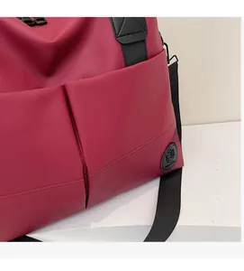 Detail of red oxford fabric backpack with dual pockets and black nylon straps
