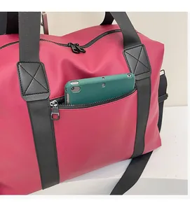 Front zipper pocket of magenta travel bag holding a tablet to show large capacity
