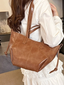 Vintage brown leather tote bag for women with large capacity and drawstring side details