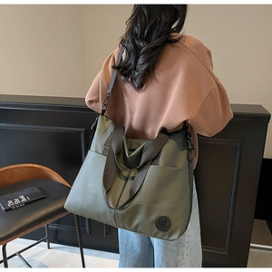 Detailed view of olive green large-capacity tote bag with durable nylon handles