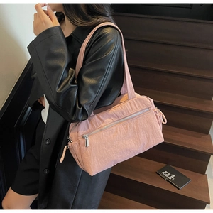 Pink nylon tote bag detail with front zipper and adjustable side drawstring design